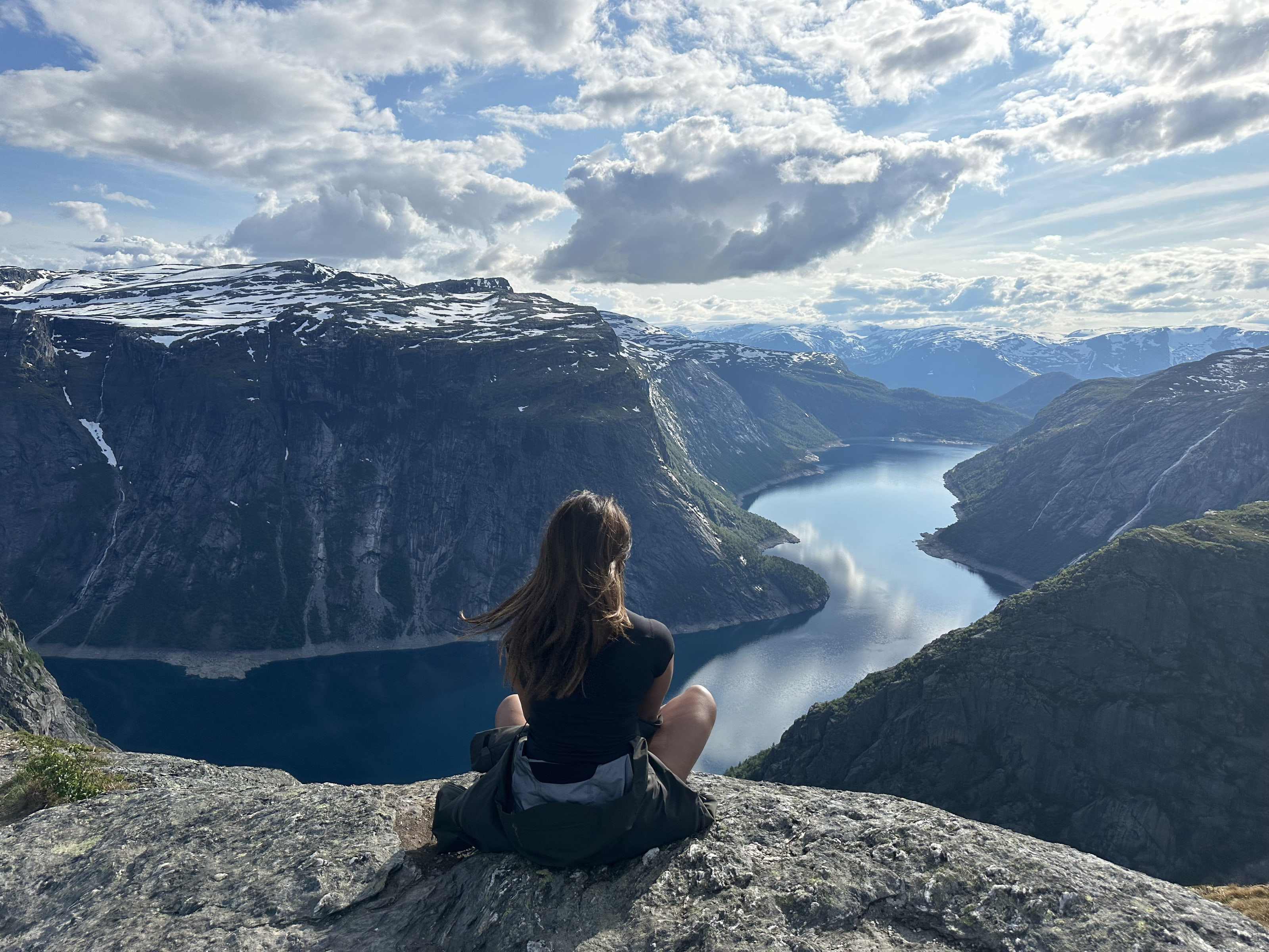 Kas Ramus looking out over a fjord from a mountain ridge